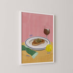 Framed art print of a plate with food, glass of wine, sock and tennis ball on a pink background.