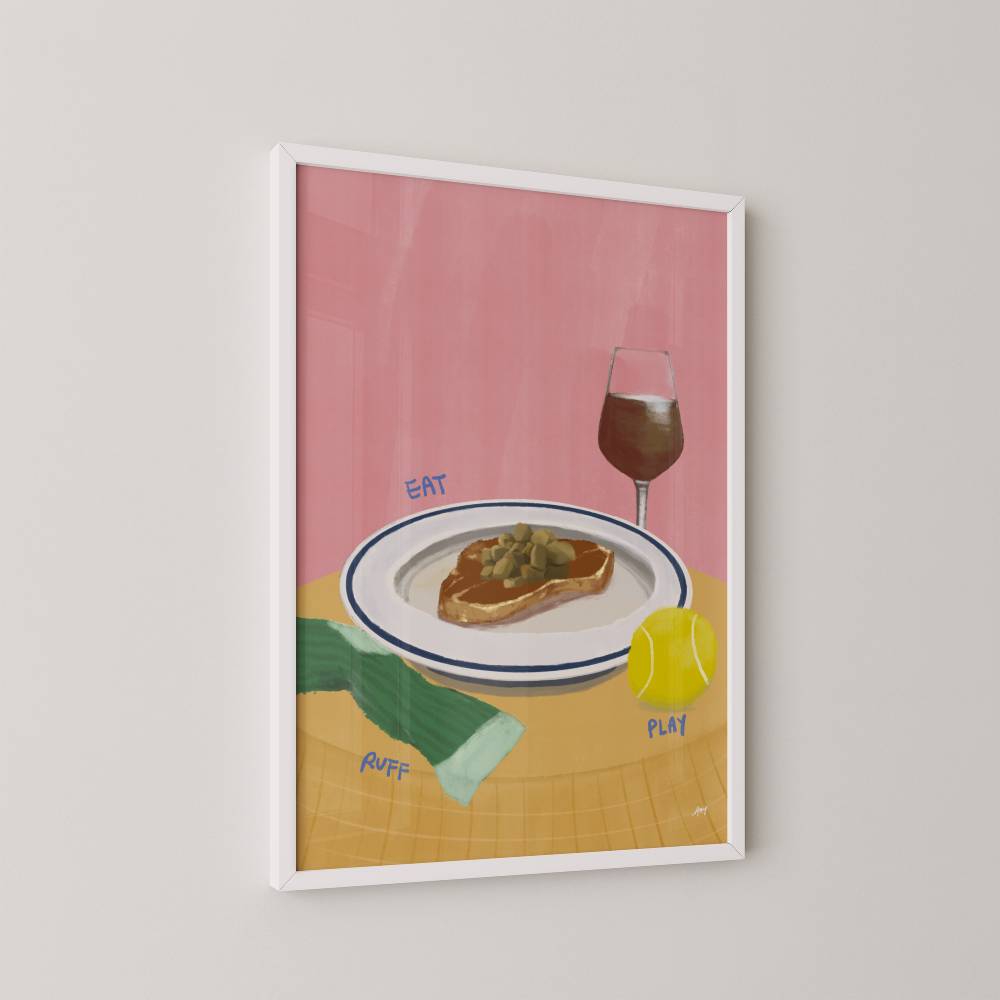 Framed art print of a plate with food, glass of wine, sock and tennis ball on a pink background.