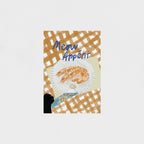 Art print with a black cat paw, plate of food, and 'Meow Appétit' text on a checkered background